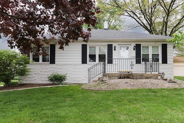 704 S Cottage Ave, Normal, IL 61761 - view of front of property featuring stone siding, a front yard, and a chimney