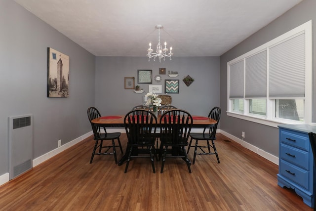 704 S Cottage Ave, Normal, IL 61761 - dining space featuring a chandelier, dark wood finished floors, and baseboards