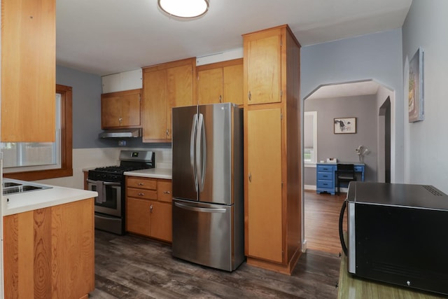 704 S Cottage Ave, Normal, IL 61761 - kitchen featuring stainless steel appliances, dark wood-type flooring, arched walkways, under cabinet range hood, and light countertops