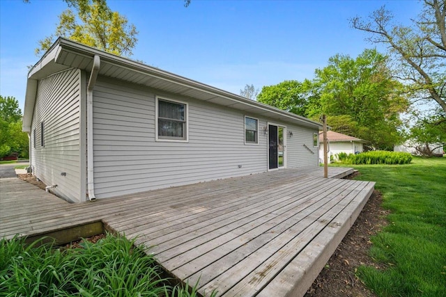 wooden terrace featuring a yard