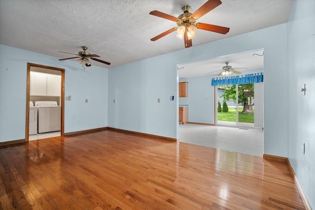 unfurnished living room featuring washing machine and dryer, wood finished floors, ceiling fan, and a textured ceiling