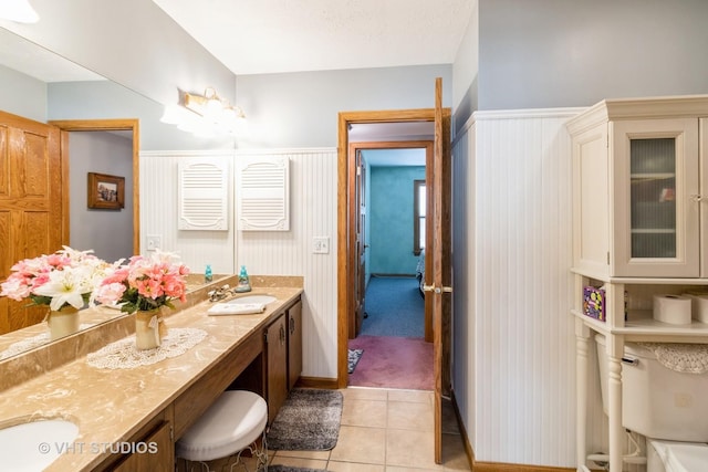 6 Sandalwood Ct, Streamwood, IL 60107 - full bathroom featuring double vanity, toilet, tile patterned flooring, and wainscoting