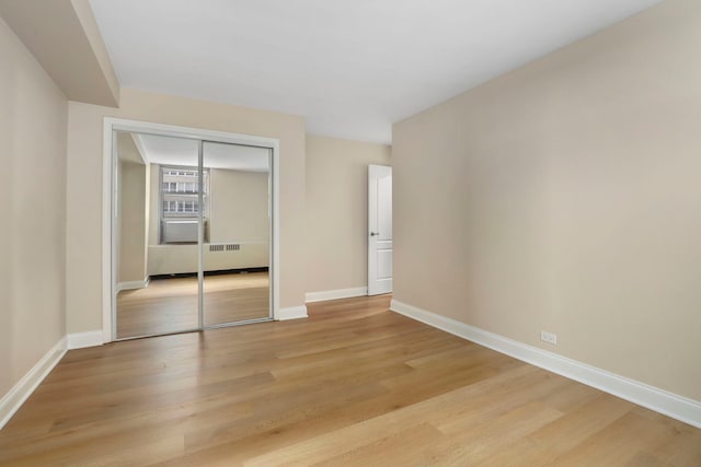 3950 N Lake Shore Dr Unit 720D, Chicago, IL 60613 - unfurnished bedroom featuring baseboards, light wood finished floors, and a closet