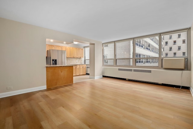 3950 N Lake Shore Dr Unit 720D, Chicago, IL 60613 - unfurnished living room featuring baseboards, light wood-style floors, and radiator heating unit