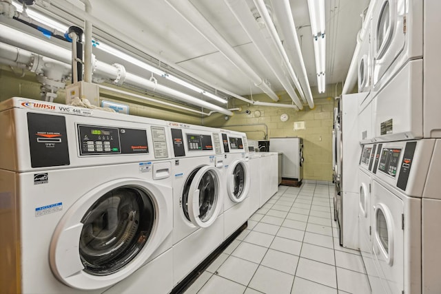 3950 N Lake Shore Dr Unit 720D, Chicago, IL 60613 - community laundry room featuring stacked washer and clothes dryer, washing machine and clothes dryer, light tile patterned floors, and concrete block wall