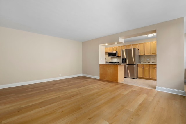 3950 N Lake Shore Dr Unit 720D, Chicago, IL 60613 - kitchen with tasteful backsplash, light wood finished floors, light countertops, baseboards, and appliances with stainless steel finishes