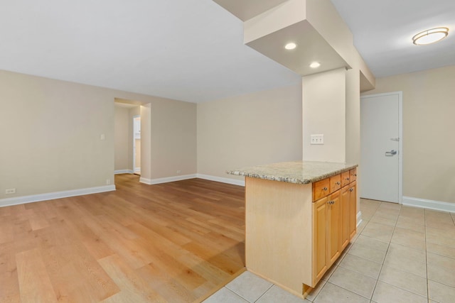3950 N Lake Shore Dr Unit 720D, Chicago, IL 60613 - kitchen featuring light wood finished floors, open floor plan, baseboards, light stone countertops, and recessed lighting