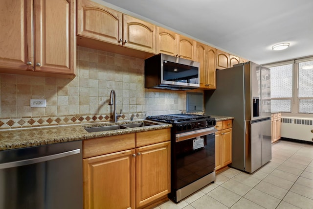 3950 N Lake Shore Dr Unit 720D, Chicago, IL 60613 - kitchen featuring radiator, appliances with stainless steel finishes, light tile patterned floors, and a sink