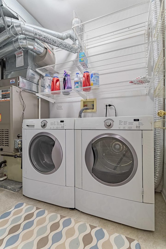 clothes washing area with washer and clothes dryer