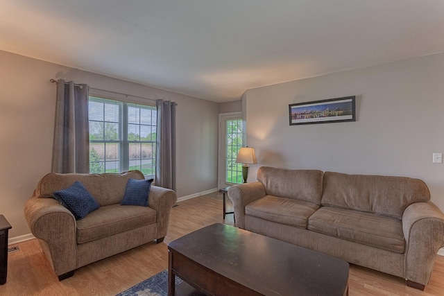 living room with light wood-style flooring and baseboards