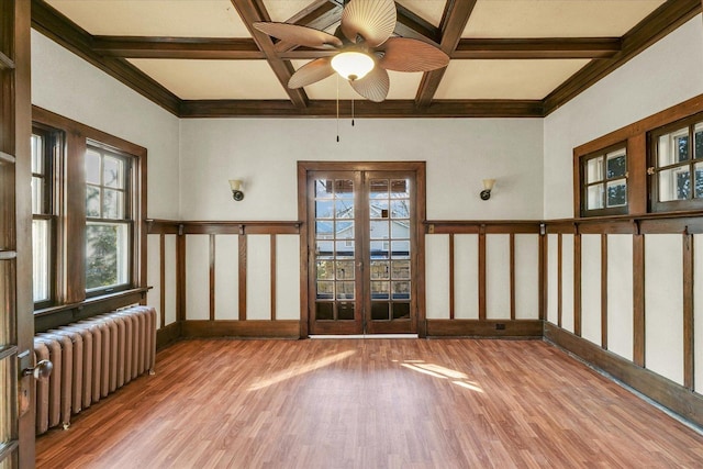 305 W Oregon St, Urbana, IL 61801 - unfurnished room featuring a ceiling fan, coffered ceiling, radiator, wood finished floors, and beamed ceiling