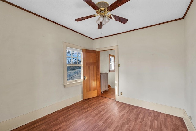 305 W Oregon St, Urbana, IL 61801 - spare room with baseboards, radiator, ornamental molding, ceiling fan, and wood finished floors