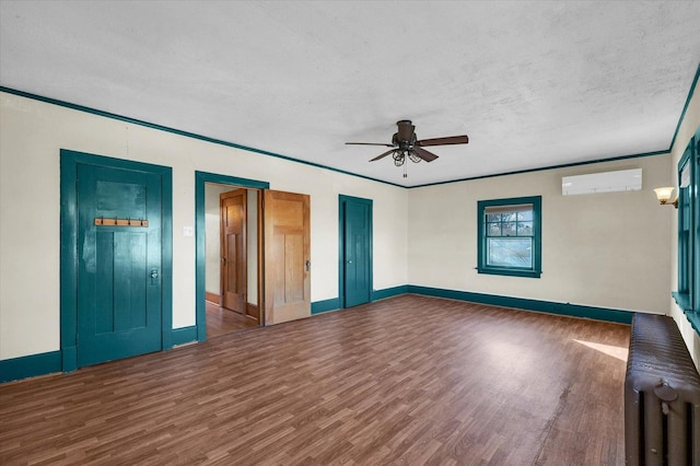 305 W Oregon St, Urbana, IL 61801 - interior space featuring a textured ceiling, wood finished floors, baseboards, and a wall unit AC