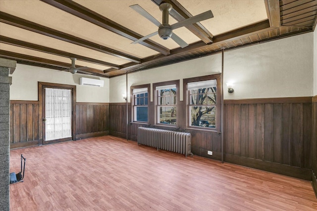 305 W Oregon St, Urbana, IL 61801 - empty room featuring wood finished floors, radiator, a wainscoted wall, beamed ceiling, and ceiling fan