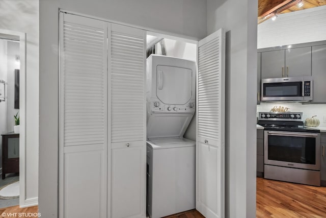 225 W Huron St Unit 507, Chicago, IL 60654 - clothes washing area featuring laundry area, stacked washer / dryer, and light wood-style flooring