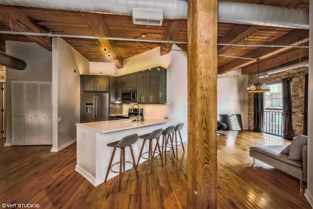 225 W Huron St Unit 507, Chicago, IL 60654 - kitchen featuring dark wood finished floors, beam ceiling, appliances with stainless steel finishes, and wood ceiling