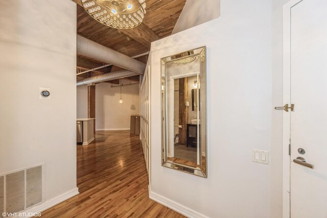 225 W Huron St Unit 507, Chicago, IL 60654 - hallway featuring baseboards, visible vents, and wood finished floors