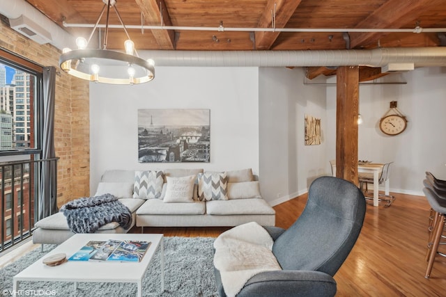 225 W Huron St Unit 507, Chicago, IL 60654 - living room with an inviting chandelier, wood finished floors, beam ceiling, baseboards, and wooden ceiling