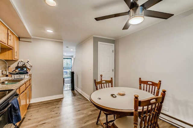 dining area featuring light wood-style flooring, baseboard heating, ceiling fan, ornamental molding, and recessed lighting