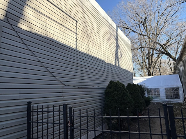 view of property exterior featuring fence