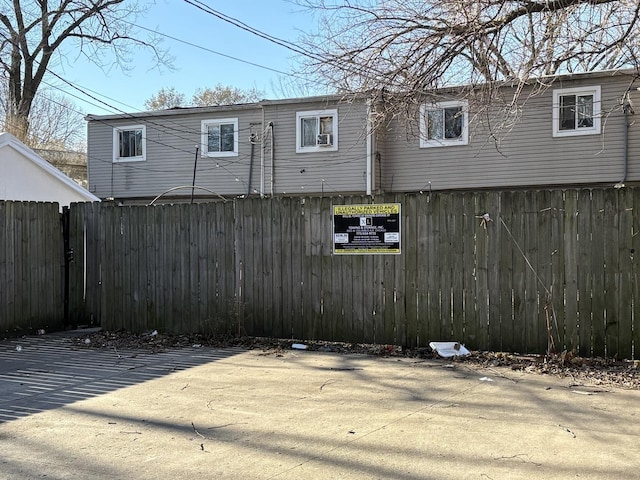 rear view of house featuring fence