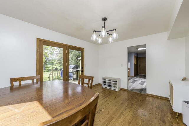 3128 Frans Ct, Winthrop Harbor, IL 60096 - dining space featuring wood finished floors, a chandelier, baseboards, and french doors