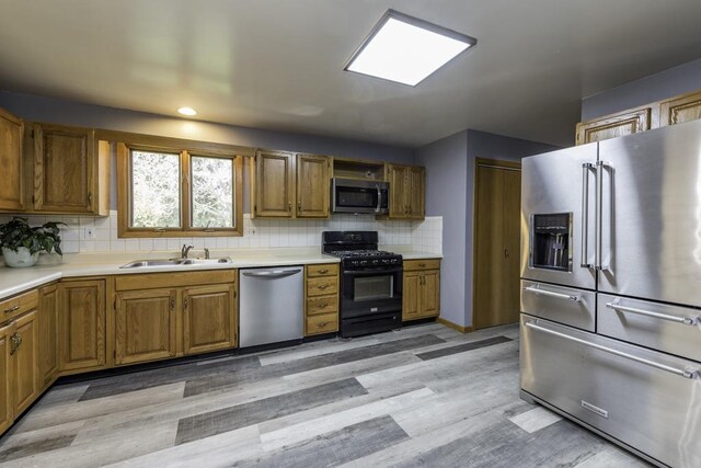 3128 Frans Ct, Winthrop Harbor, IL 60096 - kitchen featuring appliances with stainless steel finishes, a sink, brown cabinets, and recessed lighting
