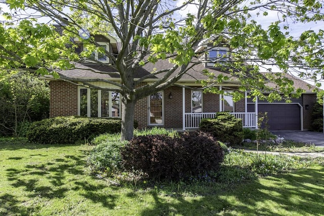 3128 Frans Ct, Winthrop Harbor, IL 60096 - obstructed view of property featuring brick siding, a front lawn, driveway, and covered porch