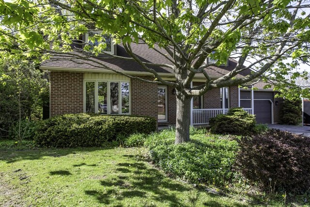 3128 Frans Ct, Winthrop Harbor, IL 60096 - view of front of house with a garage, a front yard, brick siding, and driveway