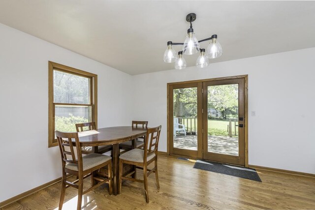 3128 Frans Ct, Winthrop Harbor, IL 60096 - dining room with a chandelier, light wood-style flooring, and baseboards