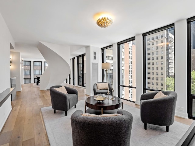 common area featuring floor to ceiling windows and stairway