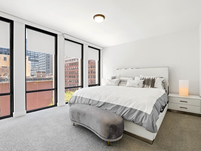 carpeted bedroom featuring a wall of windows