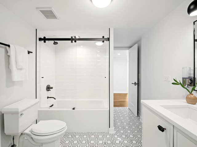 bathroom with toilet, bath / shower combo with glass door, and vanity