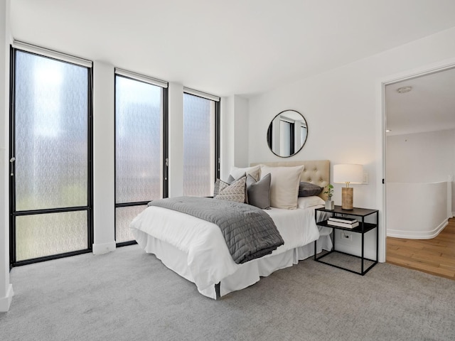 bedroom featuring baseboards and wood finished floors