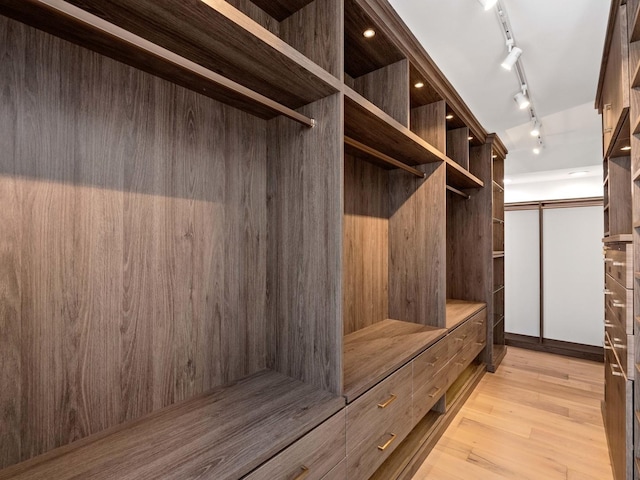 walk in closet featuring light wood-style floors