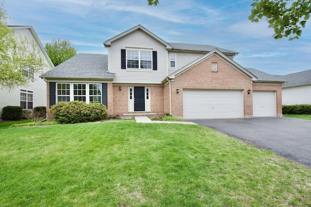 traditional home with driveway, brick siding, a garage, and a front yard