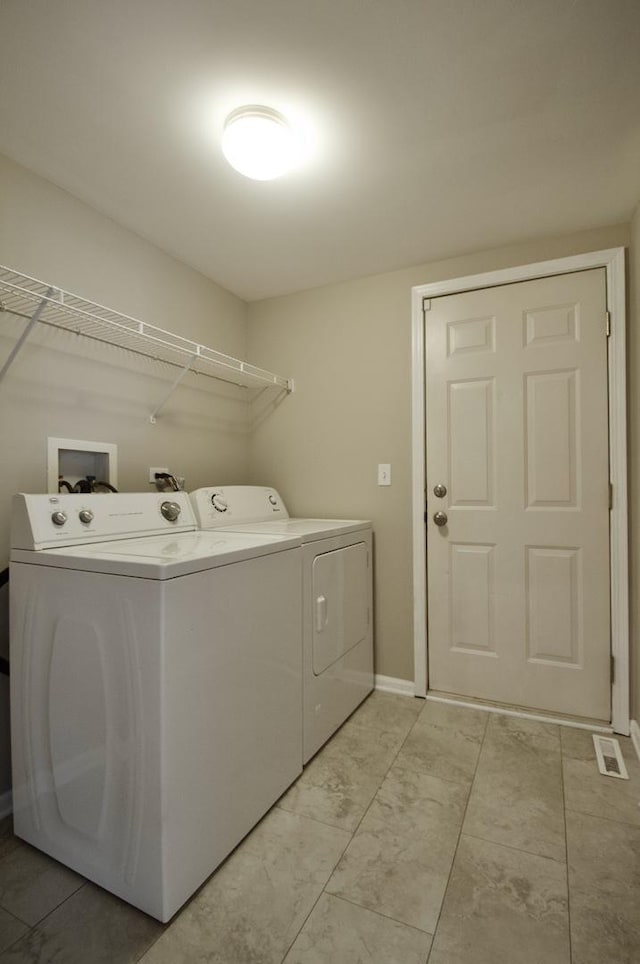 laundry area featuring washer and dryer, laundry area, visible vents, and baseboards