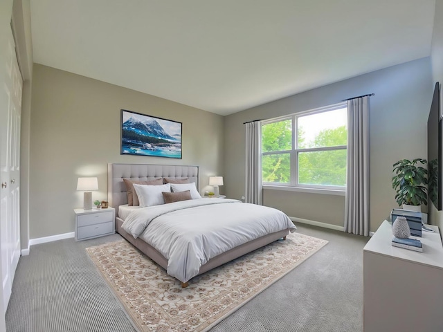 bedroom with baseboards and light carpet