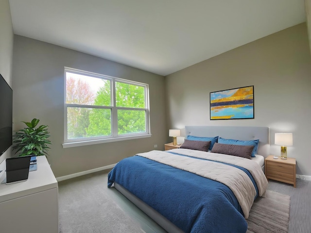 bedroom featuring light carpet and baseboards