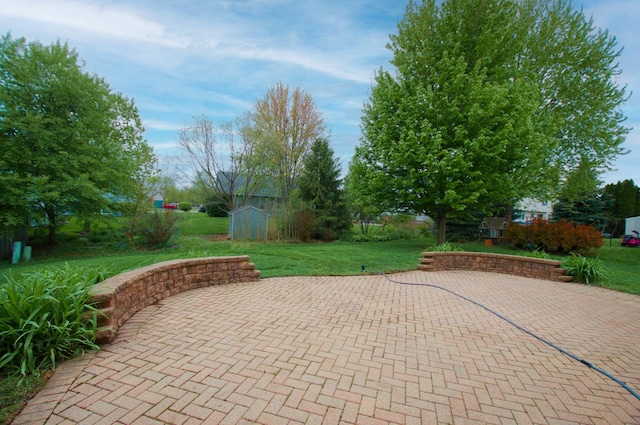 view of patio with a shed and an outdoor structure