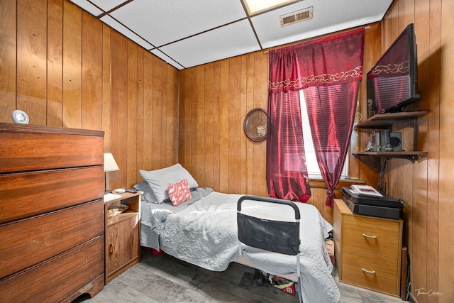 2862 S Keeley St, Chicago, IL 60608 - bedroom with a paneled ceiling, visible vents, and wooden walls