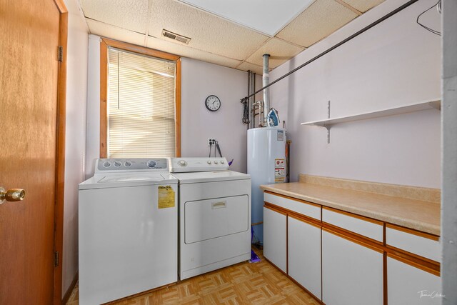 2862 S Keeley St, Chicago, IL 60608 - laundry room with cabinet space, washing machine and clothes dryer, visible vents, and gas water heater