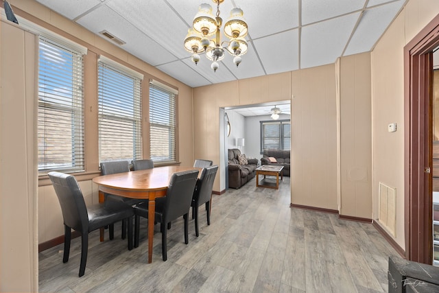 2862 S Keeley St, Chicago, IL 60608 - dining room featuring an inviting chandelier, baseboards, visible vents, and light wood-style floors