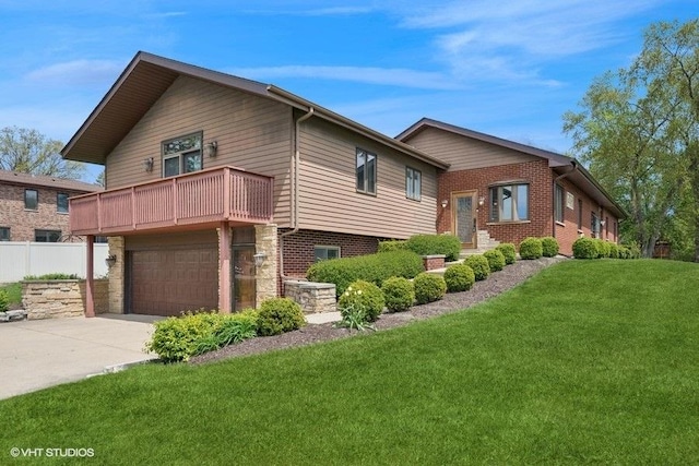 view of front of property featuring a balcony, driveway, and a garage