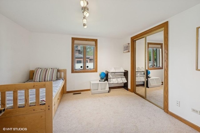 bedroom featuring carpet flooring and baseboards