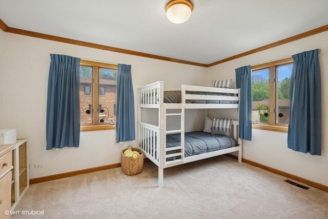 bedroom featuring multiple windows, crown molding, carpet, and baseboards
