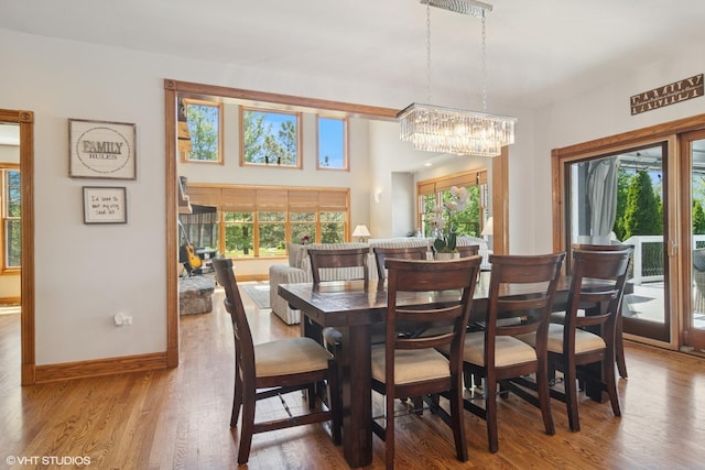 26464 N Bittersweet Trl, Mundelein, IL 60060 - dining room with a chandelier, wood finished floors, and baseboards