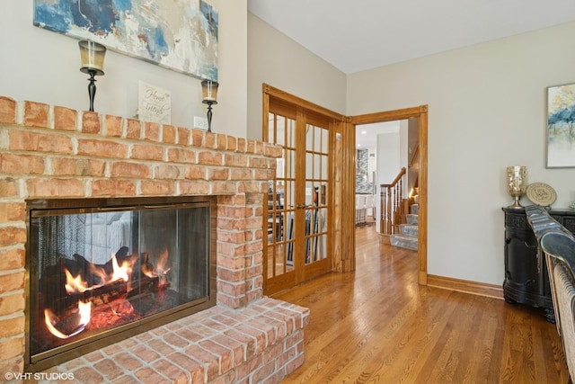 26464 N Bittersweet Trl, Mundelein, IL 60060 - living area with a fireplace, wood finished floors, baseboards, and stairs