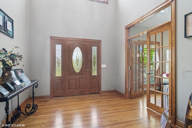 26464 N Bittersweet Trl, Mundelein, IL 60060 - foyer entrance featuring light wood-style floors, a towering ceiling, french doors, and baseboards