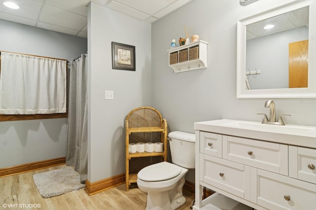 26464 N Bittersweet Trl, Mundelein, IL 60060 - bathroom featuring toilet, wood finished floors, vanity, a paneled ceiling, and baseboards